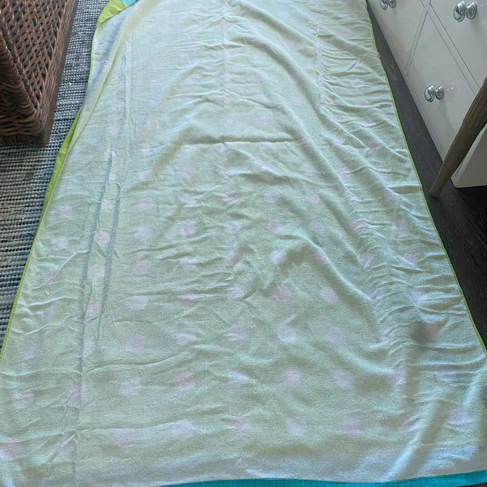 Green, pink, white, and blue beach towel